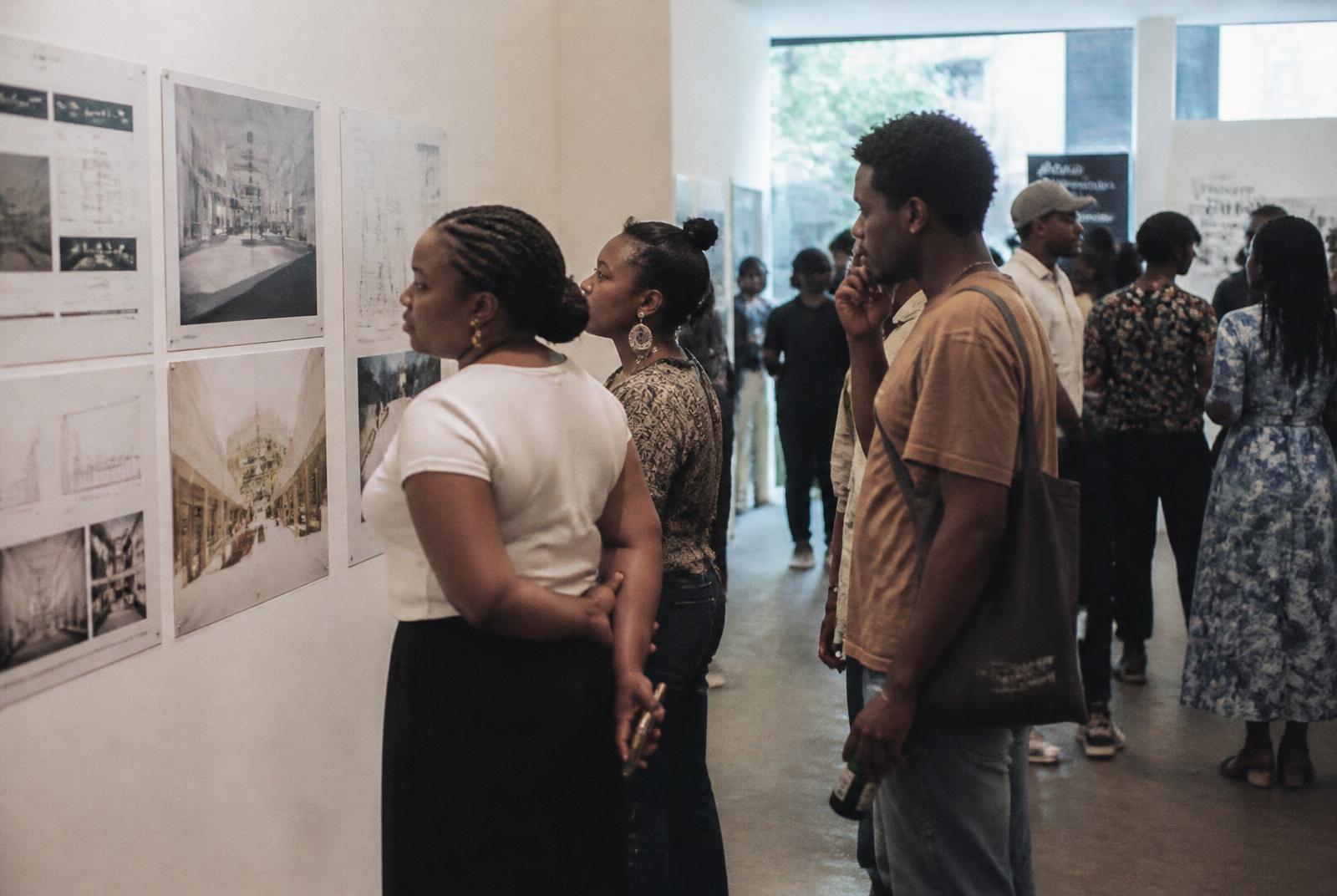 Visitors reading architectural drawings in the exhibition hall